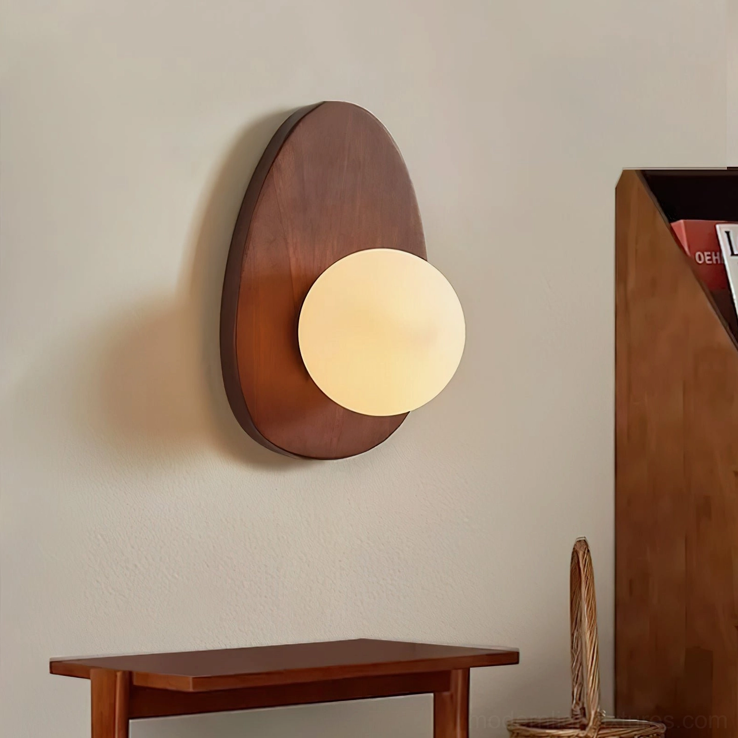 Oval base wall sconce in entryway setting, solid wood backplate with matte glass shade, mid-century modern