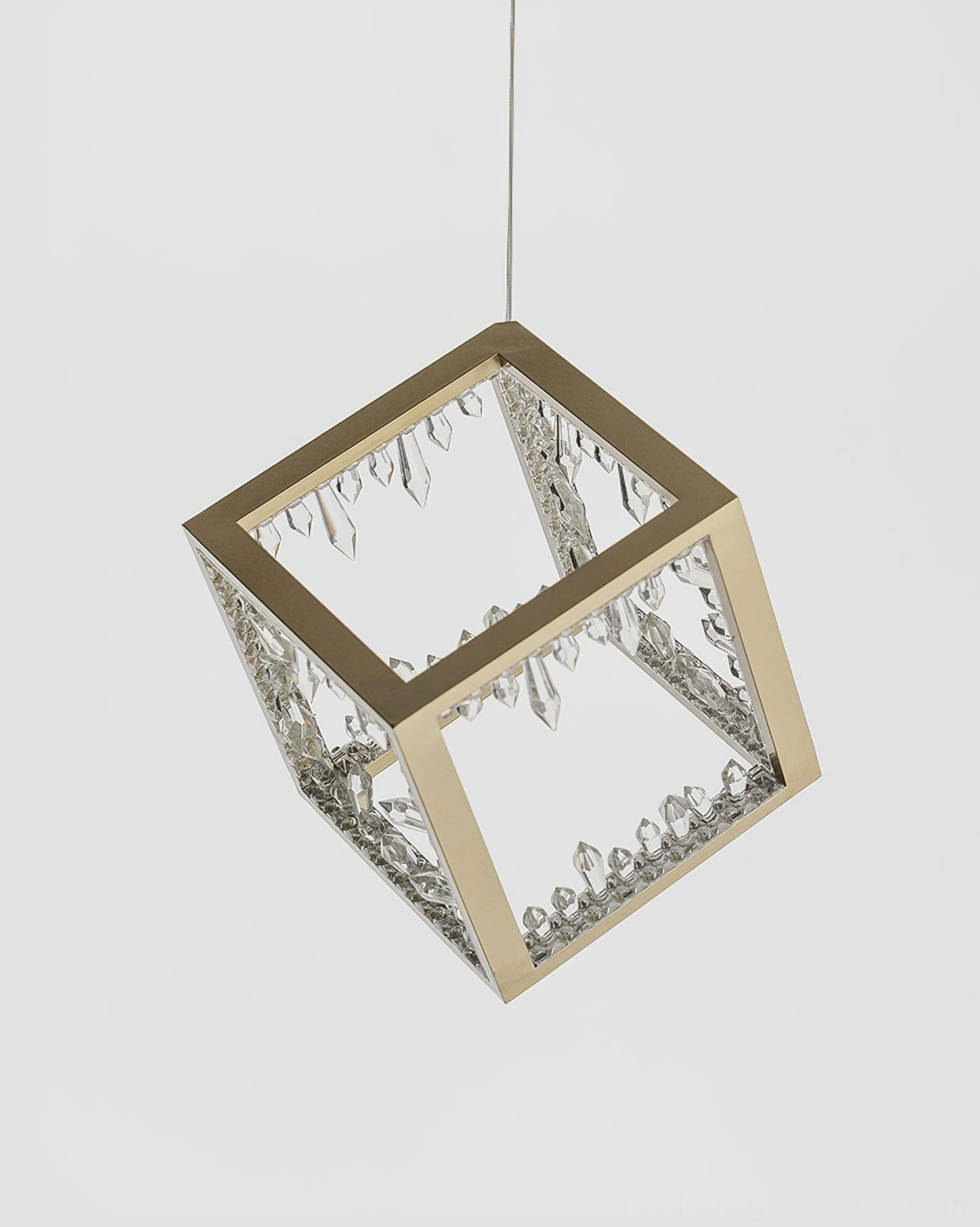 Overhead view of gold-framed cube pendant lamp showing crystalline inner panels and light diffusion