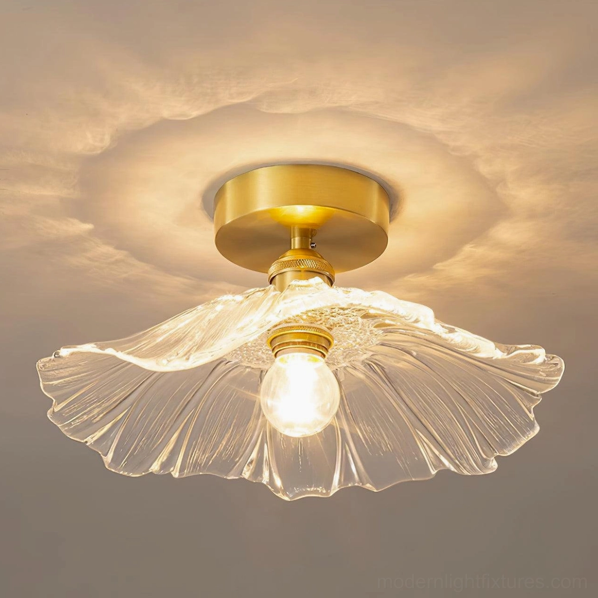 Overhead installed view of ruffled glass semi-flush ceiling light fixture with visible brass mount and clear shade