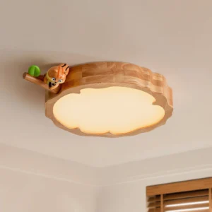 Overhead view of handcrafted woodland animal ceiling lamp showing warm diffused glow and solid wood construction