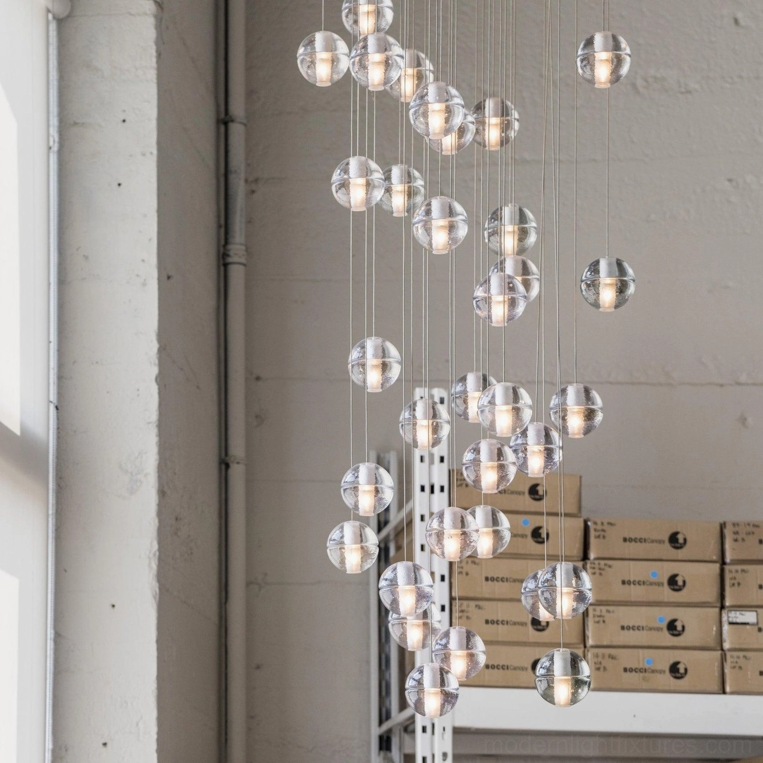 Large oversized K9 crystal cluster chandelier with dense pendant heads in contemporary space