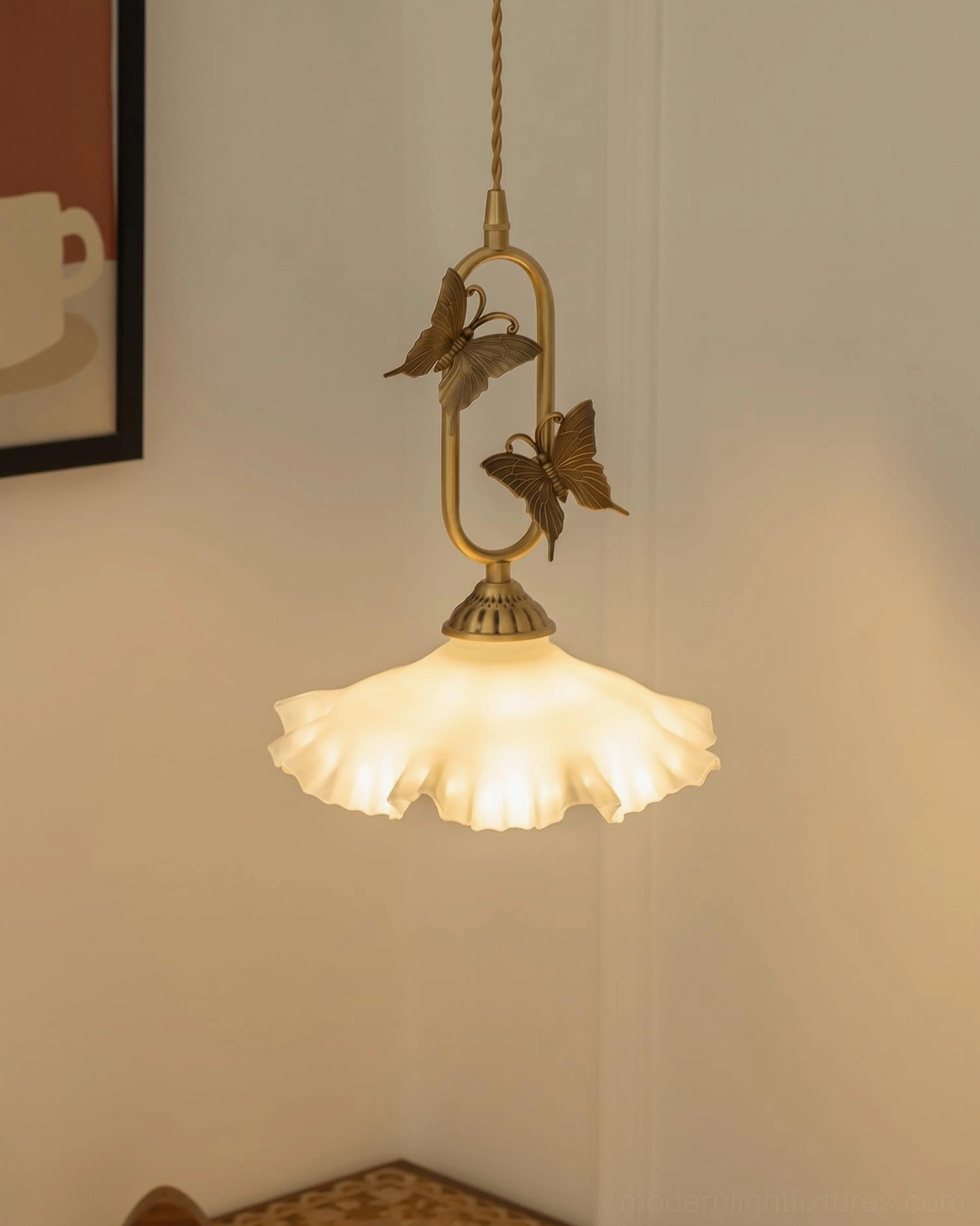 Pair of brass butterfly pendant lights flanking bed, white jade frosted shades as bedside ambient lighting