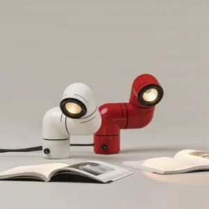 Two matching industrial tubular table lamps overhead view on tabletop with magazines minimalist design