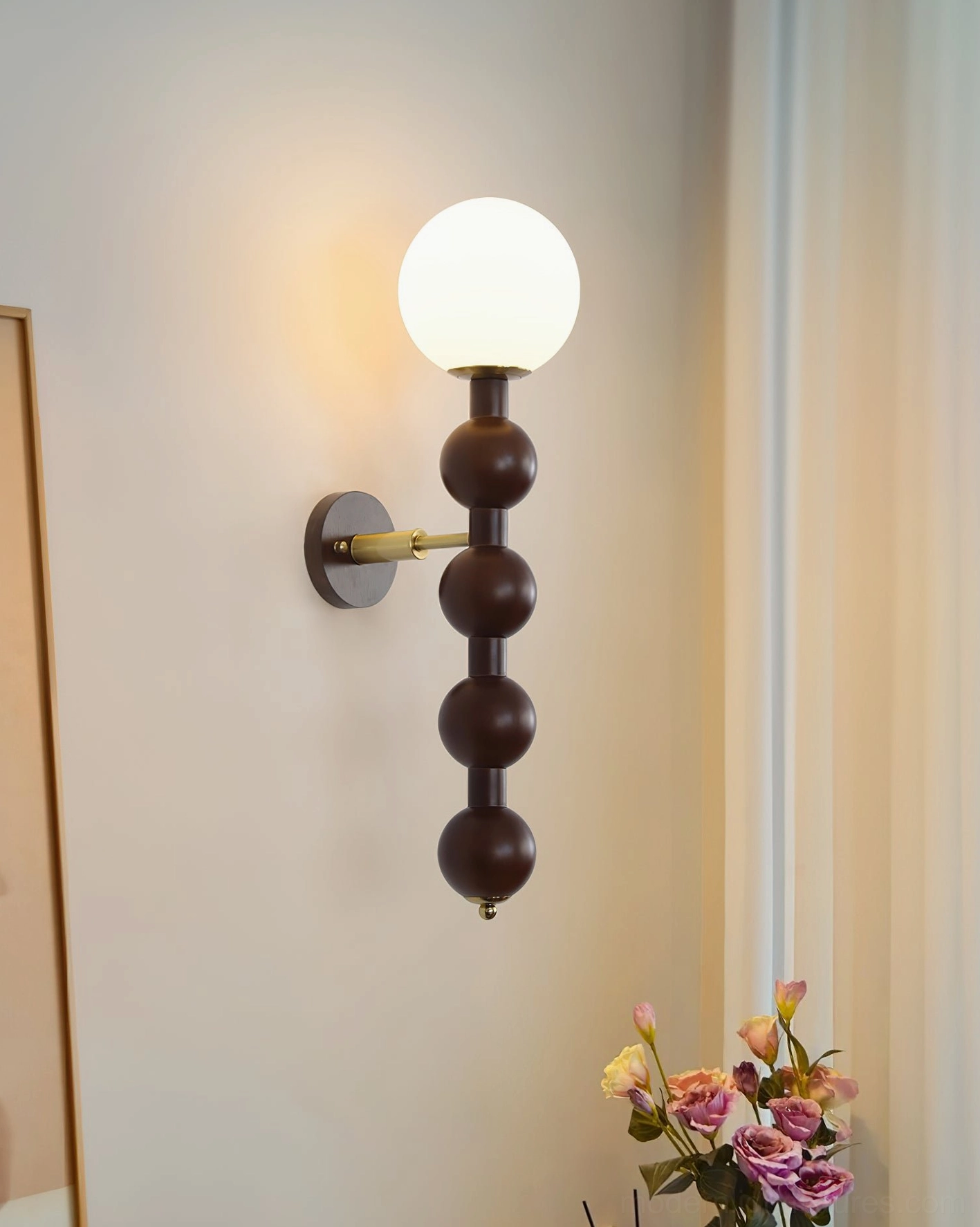 Paired Selene beaded globe wall sconces flanking bedroom headboard in spa-like setting