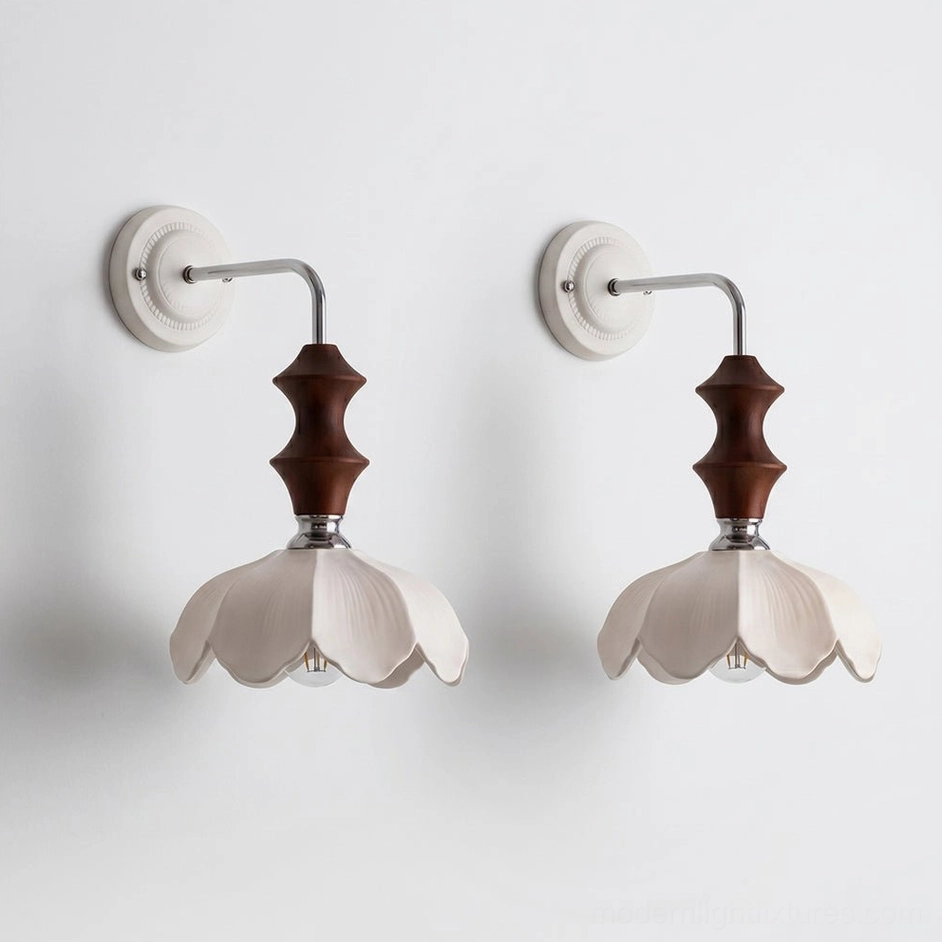 Pair of ceramic floral wall sconces with white petaled shades symmetrically mounted for balanced design