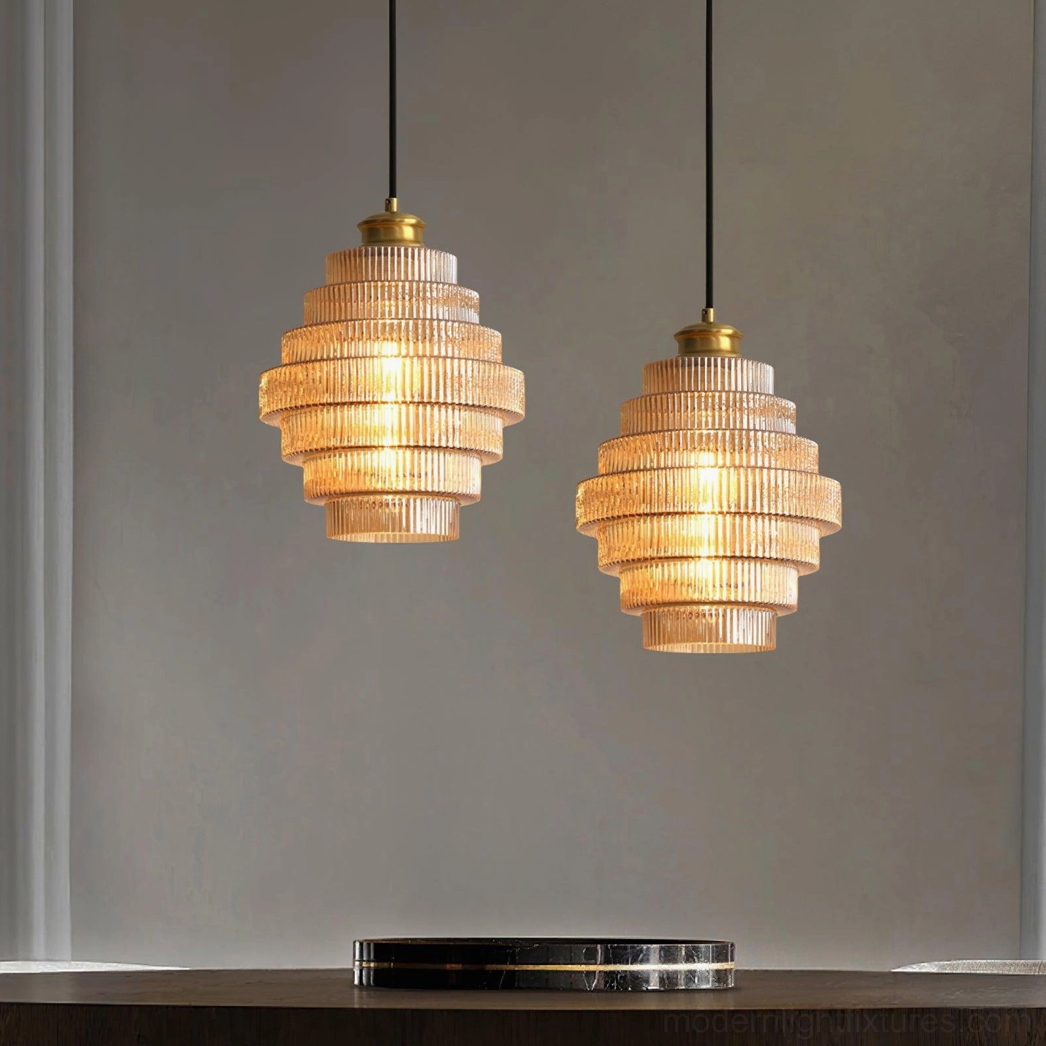 Two matching ridged glass pendant lights in modern interior, low angle view with console table