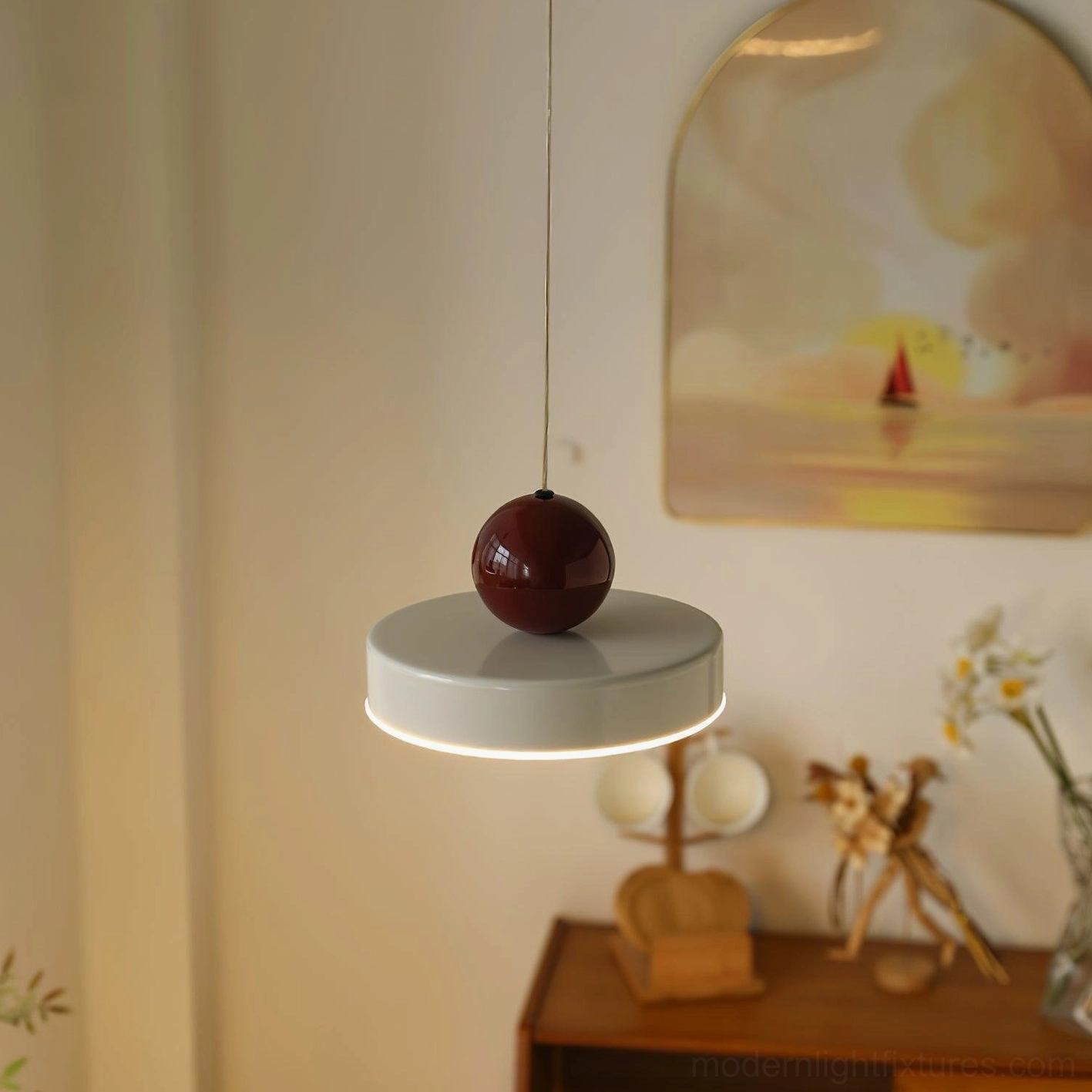 Pallade metal pendant light with geometric sphere design in home setting