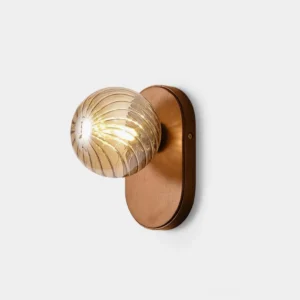 Paola ribbed glass orb wall sconce with amber glass shade and brushed metal backplate - front studio view