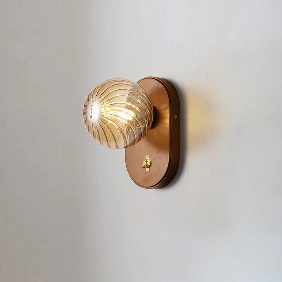 Paola orb wall sconce model B with walnut color and amber glass in luxury home setting