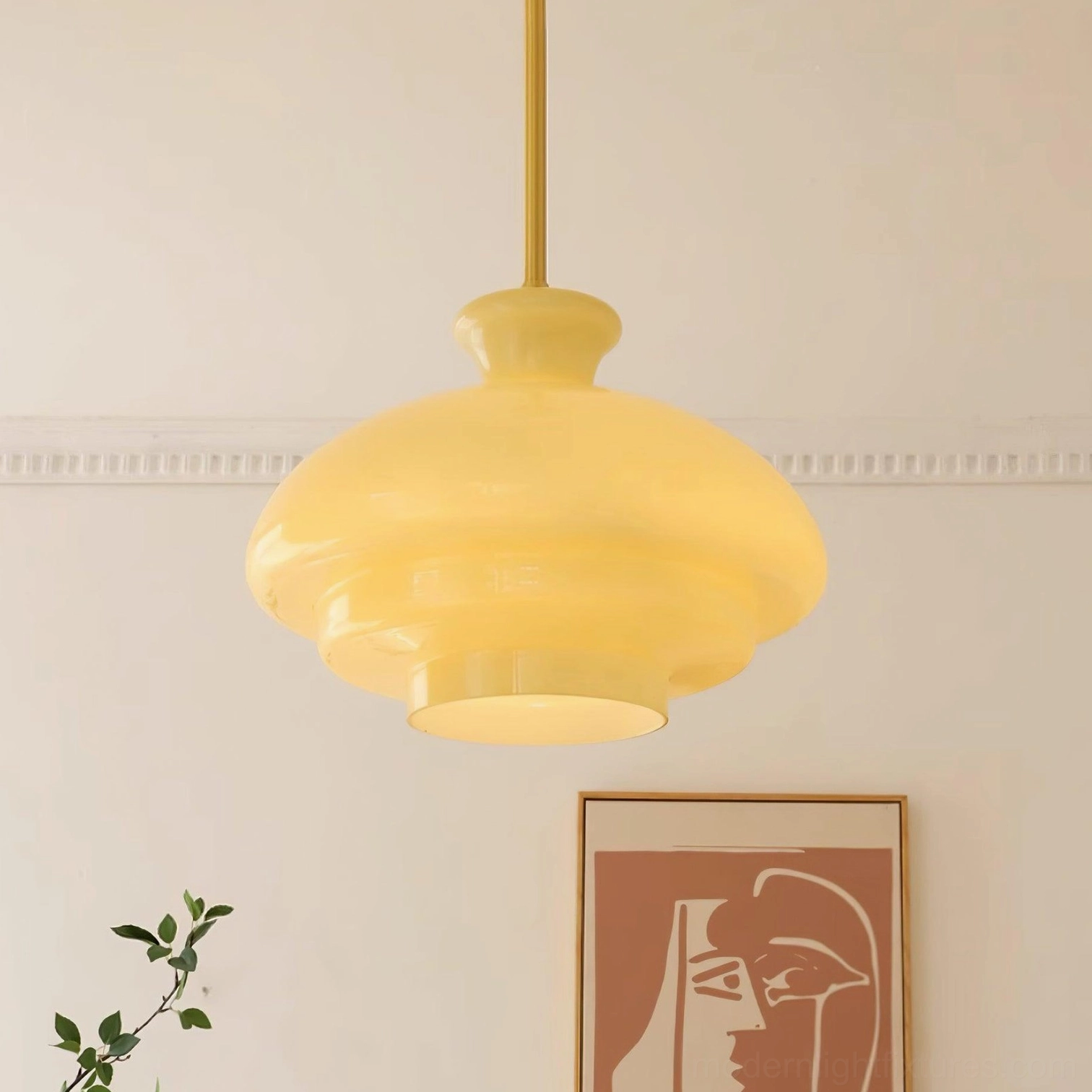 Paolina tiered glass pendant light in beige shade with brass suspension rod, hanging in mid-century modern living room setting