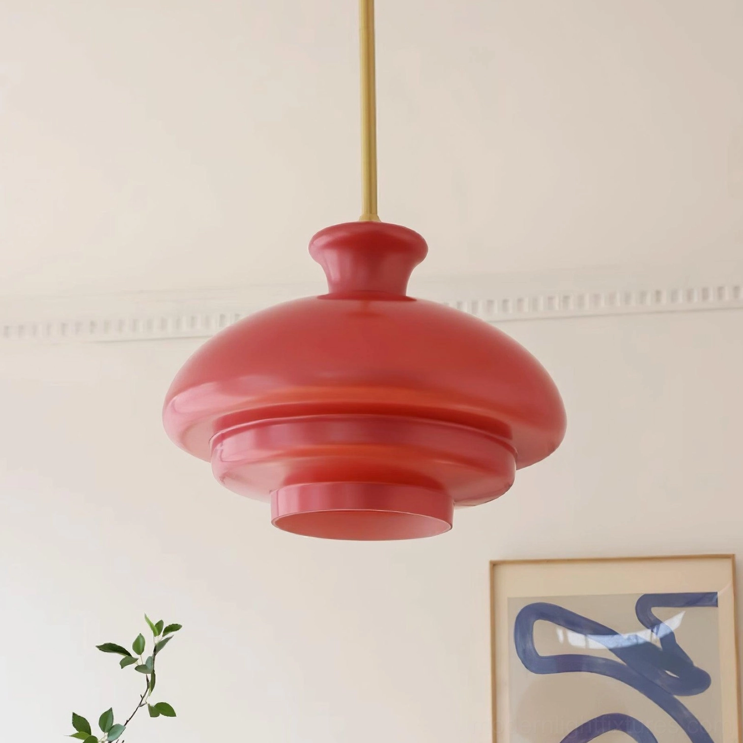 Paolina tiered glass pendant lamp suspended over dining area, mid-century modern style with warm ambient illumination