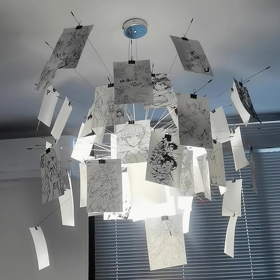 Paper pendant light upward angle shot with monochrome printed art cards in room with window blinds