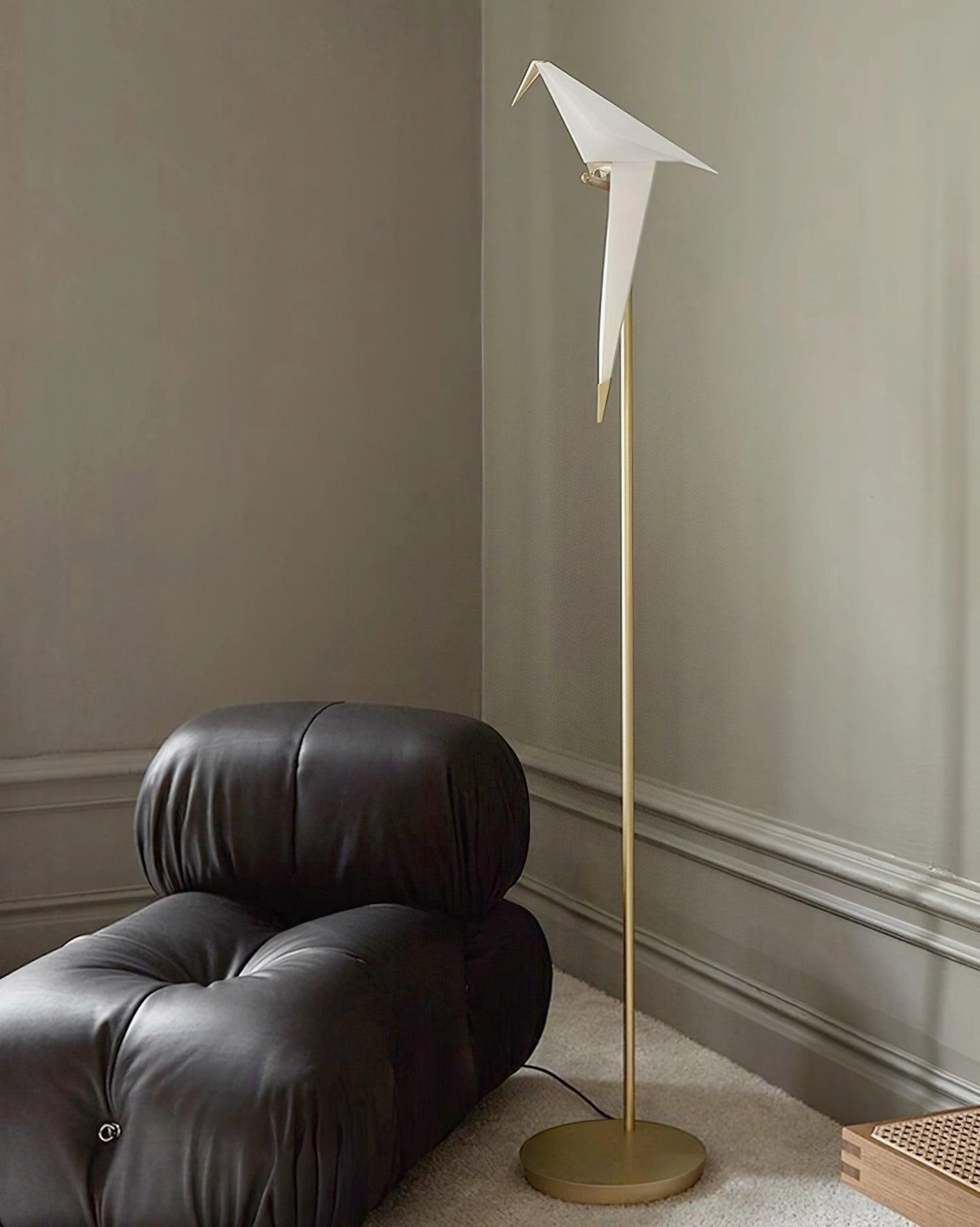 Modern minimalist paper crane floor lamp showing elegant brass metalwork and sculptural design