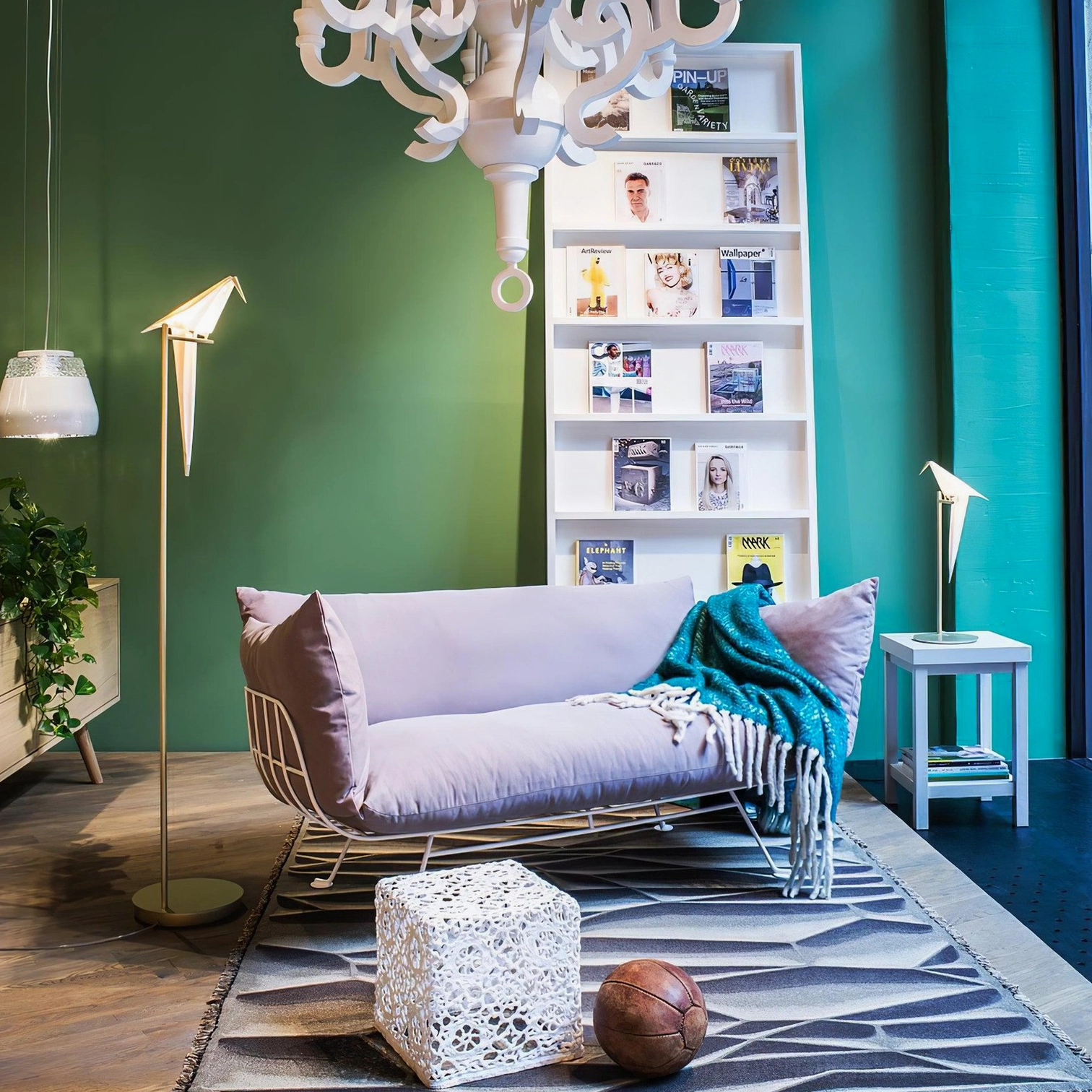 Coordinated paper crane floor and table lamps in modern living room with green accent wall