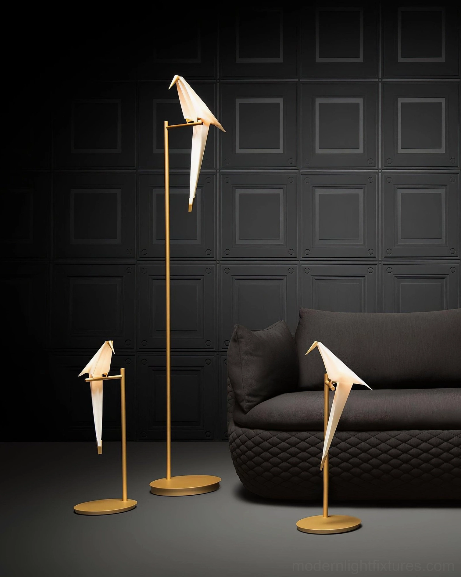 Assorted paper crane floor and table lamps with brass hardware in dark modern interior