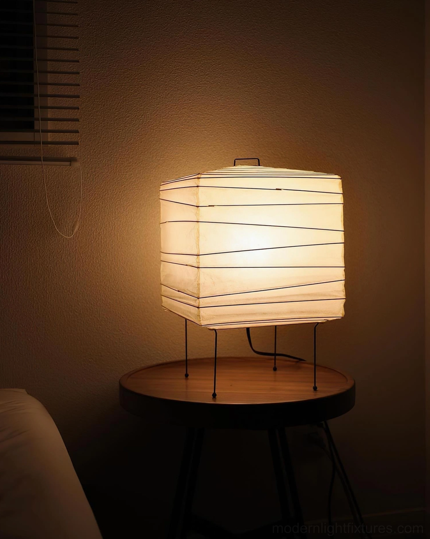 Japanese-inspired folded paper cube lamp with integrated handle detail and black metal frame construction