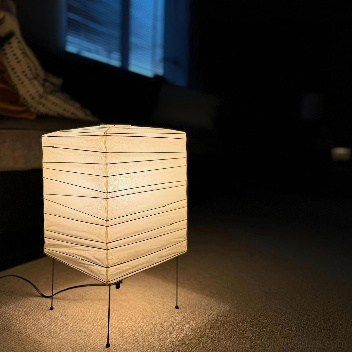 Portable minimalist paper cube lamp with integrated handle for easy repositioning and transport