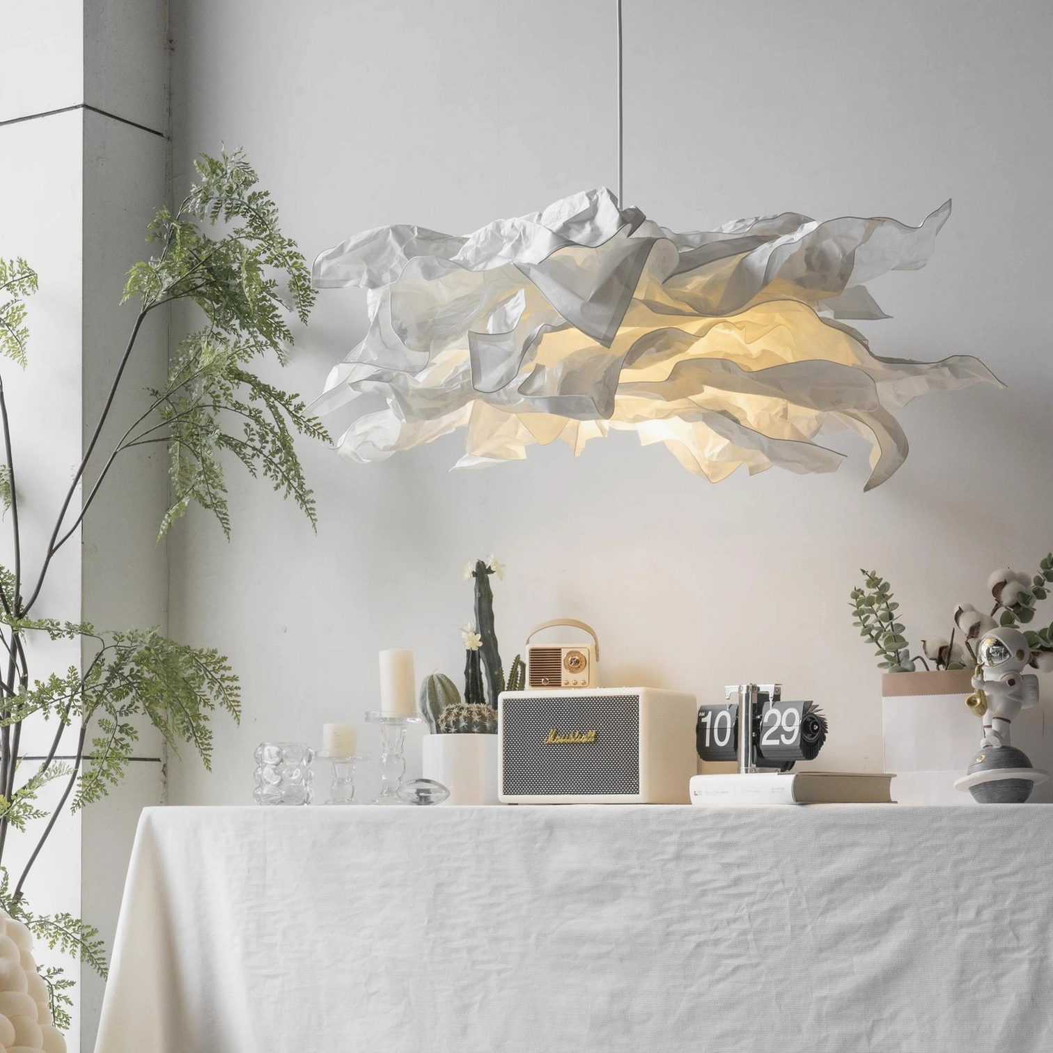 Contemporary paper pendant lamp in minimalist dining room with warm ambient lighting and Nordic interior design