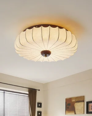 Papilio ceiling lamp installed in residential interior with warm glowing light and dark wood accent base