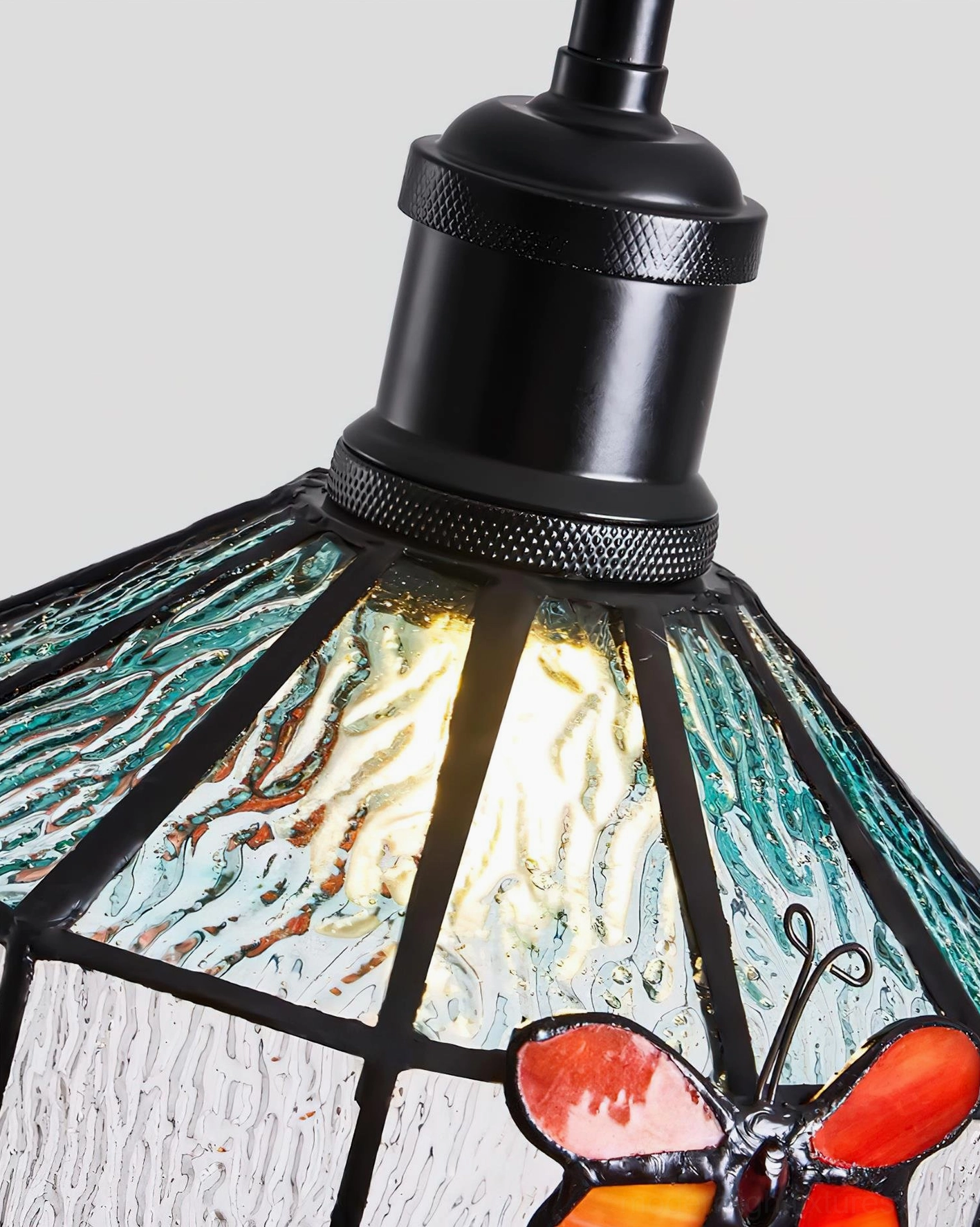 Papilune stained glass pendant light macro close-up showing black metal fixture butterfly detail and quality glass craftsmanship
