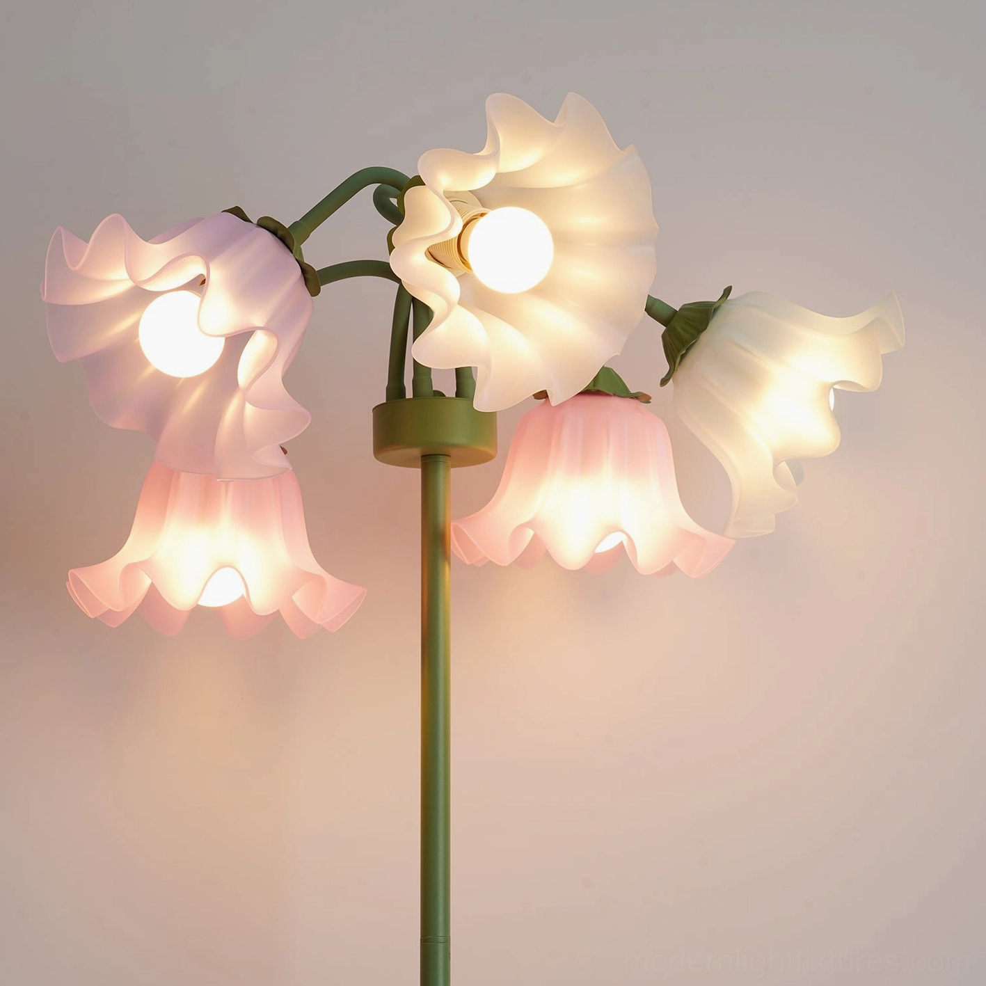Front close-up of fully lit pastel lily of the valley floor lamp showing complete warm glow from all shades