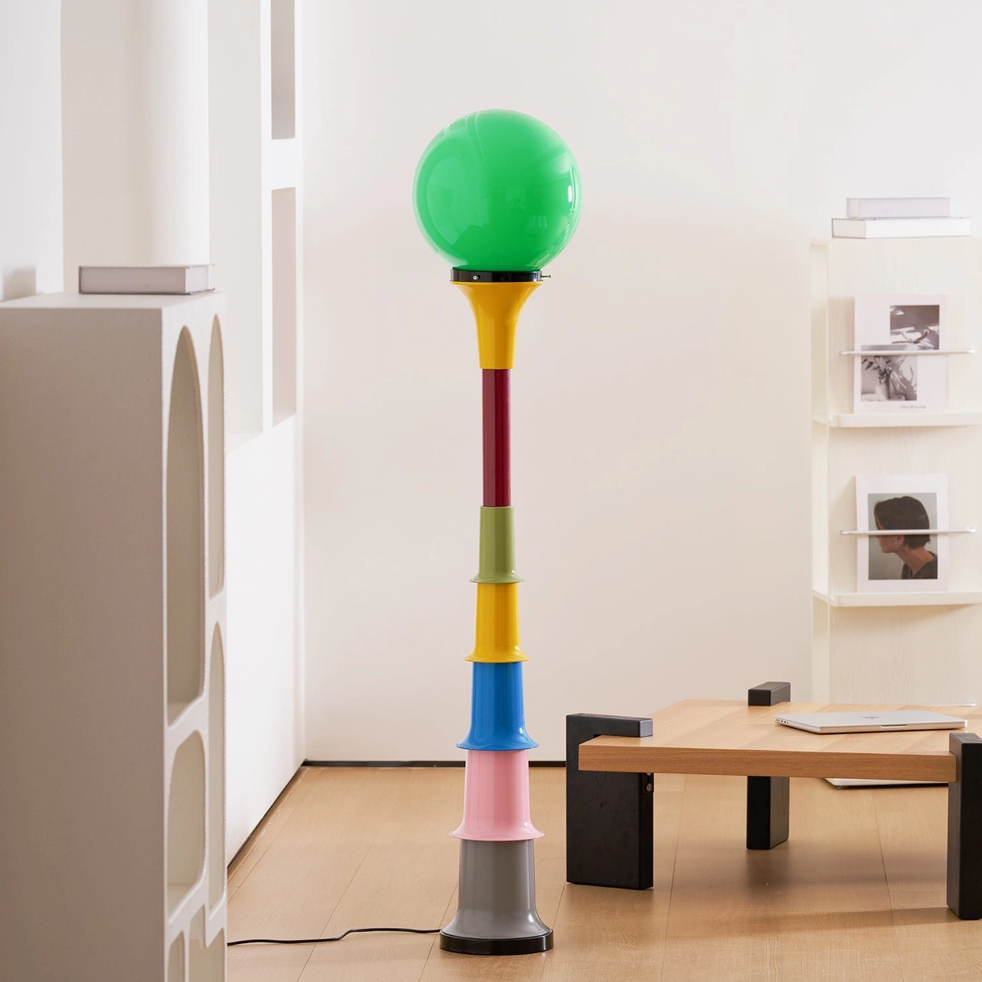 Modern globe floor lamp with pastel color-blocked base in styled interior setting