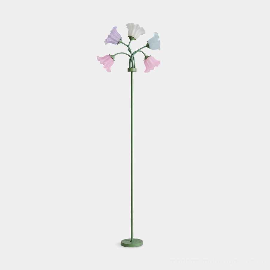 Pastel lily of the valley floor lamp with green metal stand and multicolor bell-shaped glass shades on white studio background
