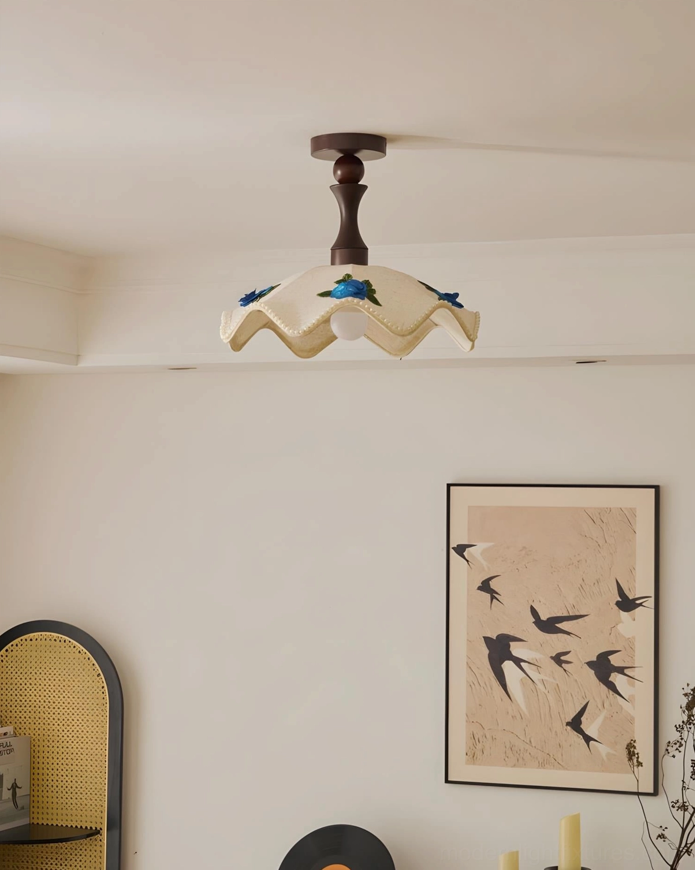 Embroidered scalloped ceiling lamp in corner view with rattan chair and transitional living room decor