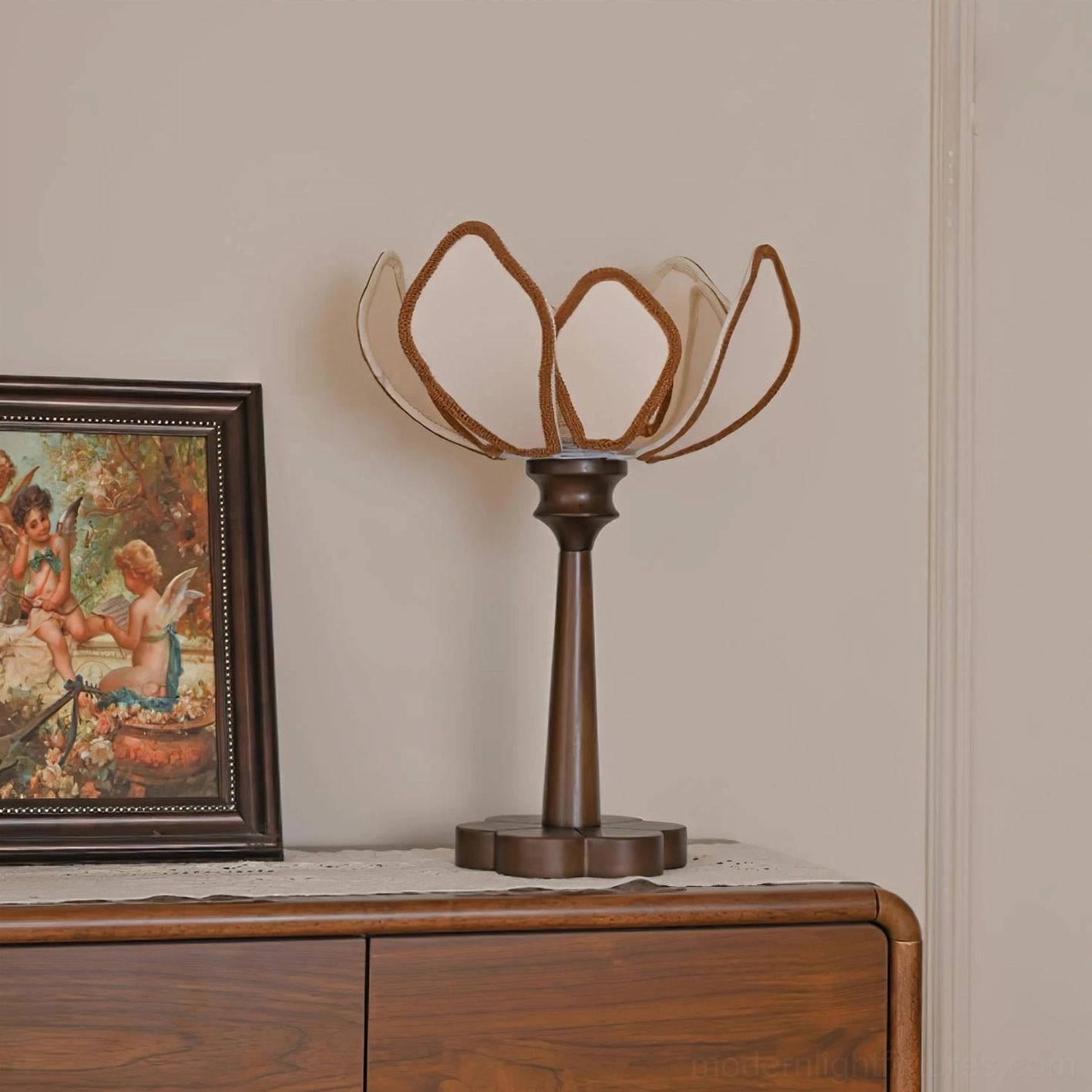 Pauline vintage table lamp illuminated showing warm glow and botanical petal structure in bedroom setting