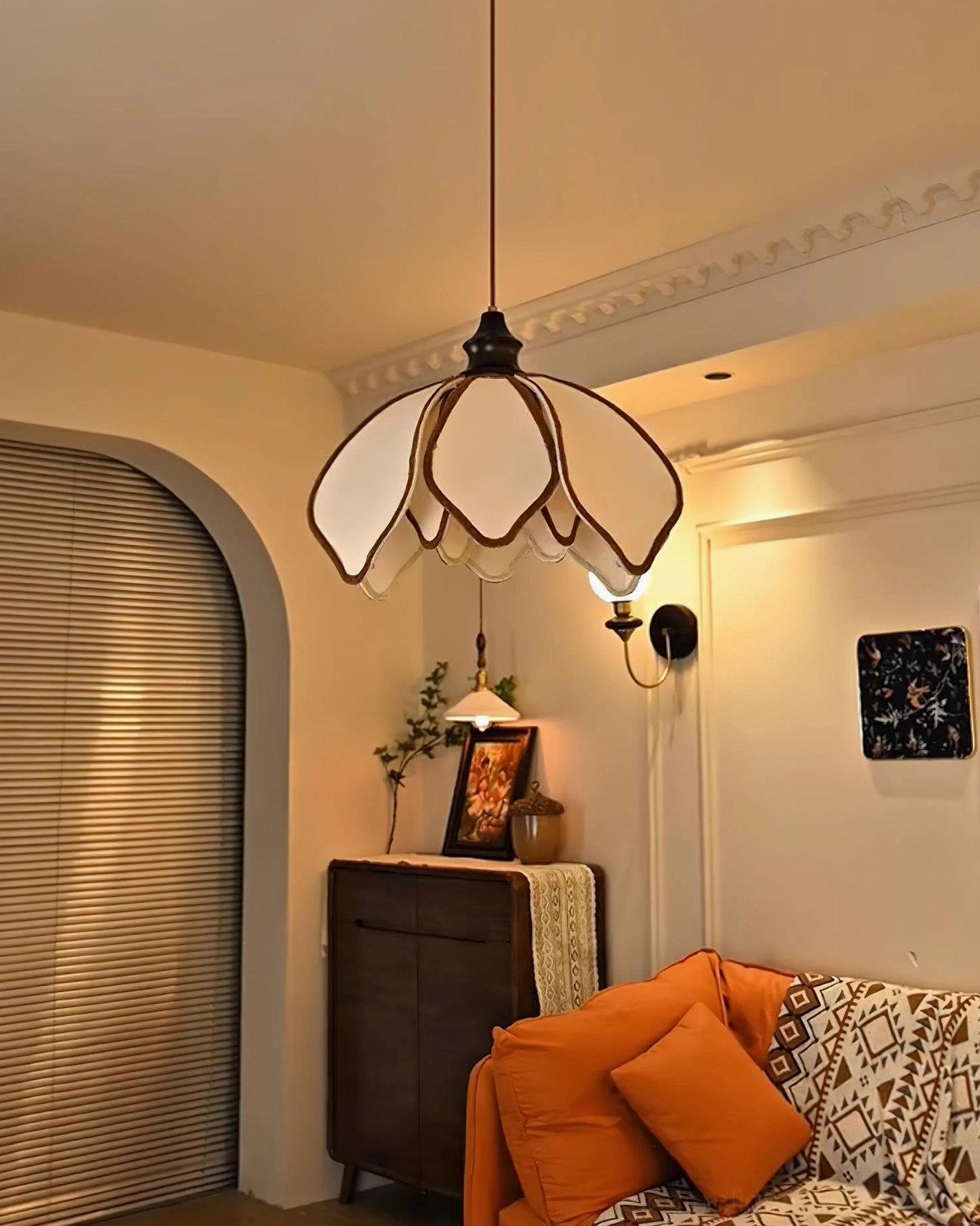 Pauline petal pendant light three-quarter side view in living room with arched window, neutral warm-toned interior