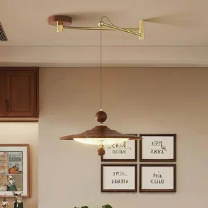 Swing arm pendant light installed in modern dining room, warm ambient lighting over dining table with wall art decor, architectural light fixture