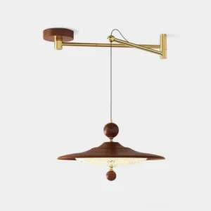 Pavilion swing arm pendant light in mid-century modern design, front studio view with walnut and brass finishes, sculptural acrylic shade with carved wood accents