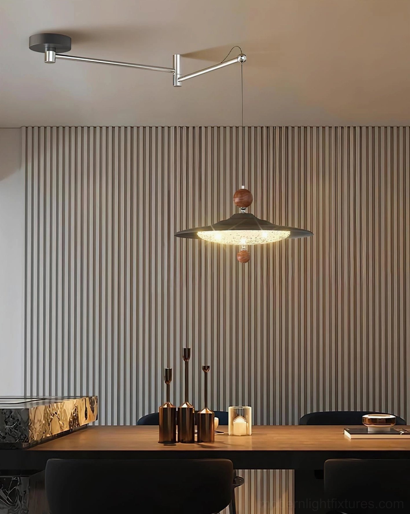 Modern pendant light with swing arm in minimalist interior, installed above dining table with fluted wall paneling, sculptural lighting design