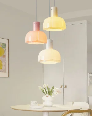 Three-head Pavina pendant light set in mixed colors (pink, cream, white) hung over dining table in modern kitchen