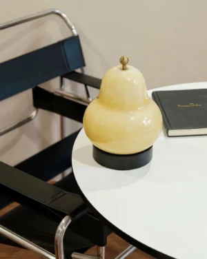 Beige pear-shaped table lamp on white round table dining corner warm glow modern home decor