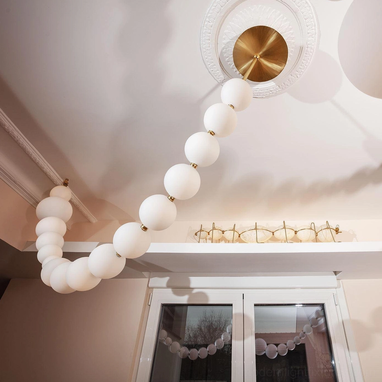 Contemporary pearl necklace chandelier spheres with integrated LED illumination creating soft ambient glow