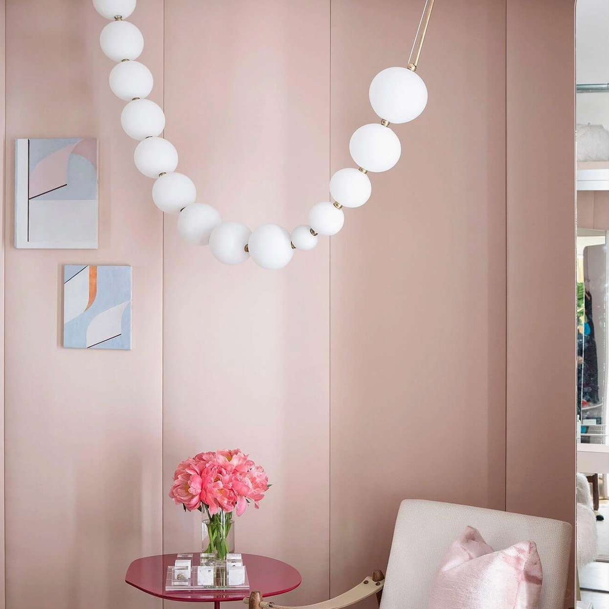 High-end retail showroom pearl chandelier display with circular ring configuration and frosted acrylic globes