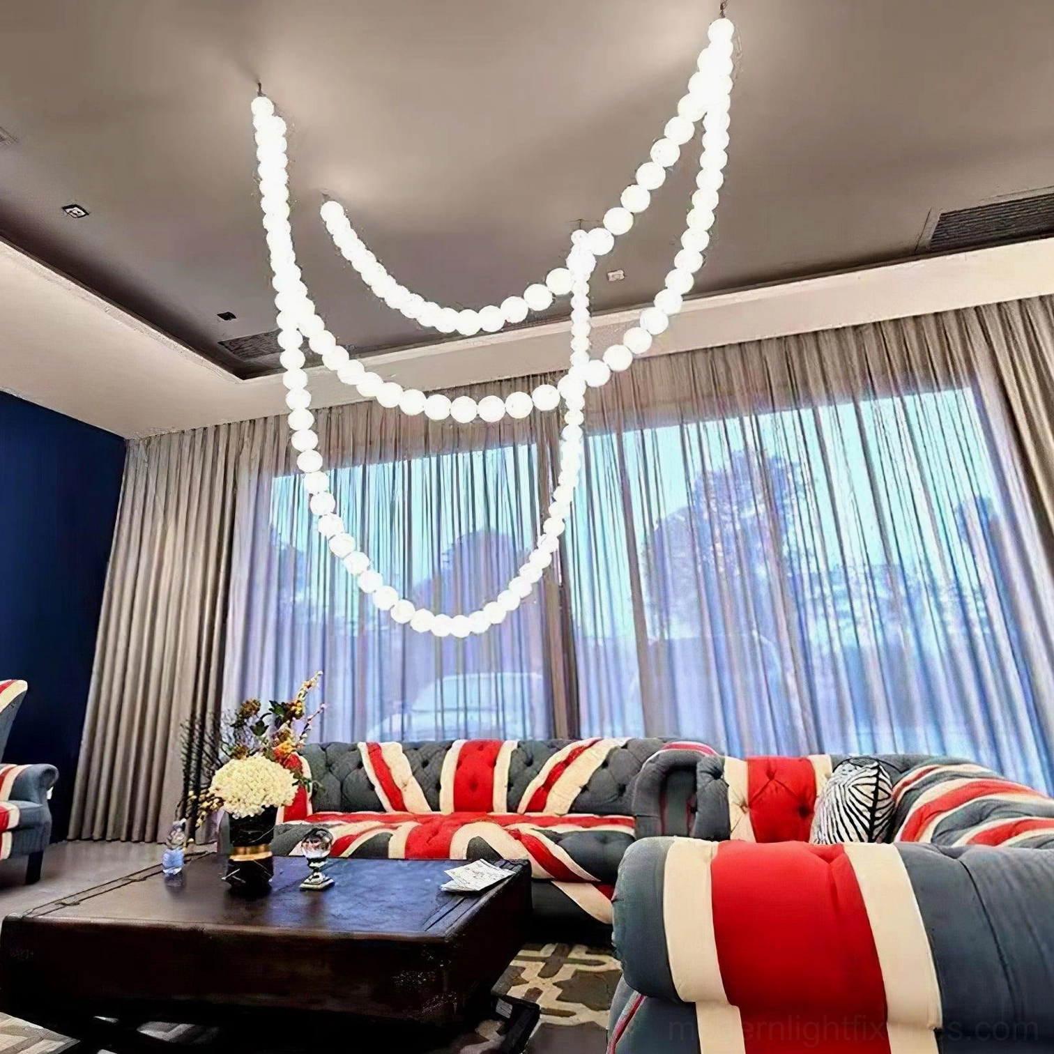 Modern pearl necklace chandelier in minimalist space with clean lines and architectural detail