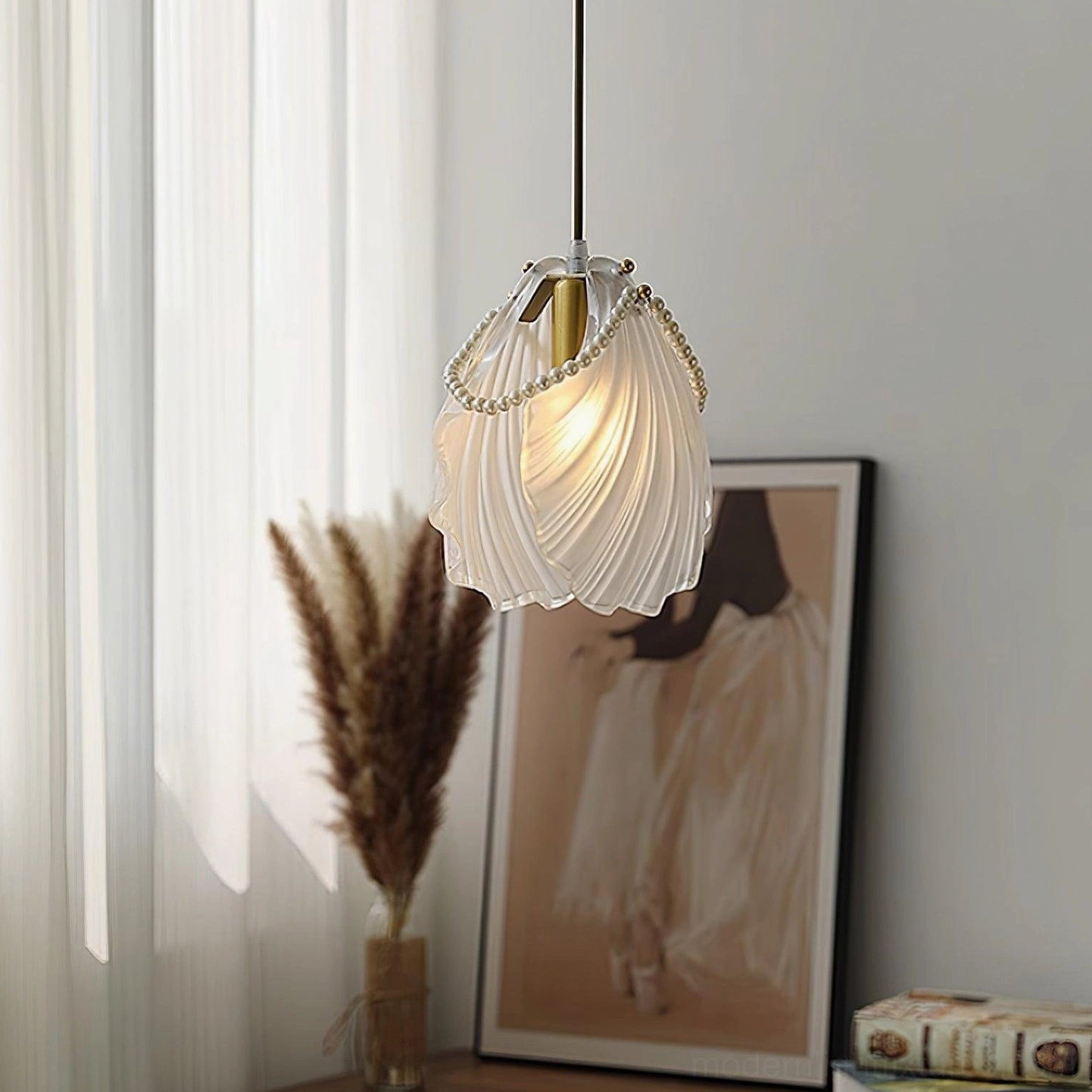 Pearl shell pendant light three-quarter angle with ruffled frosted glass and warm glowing ambiance