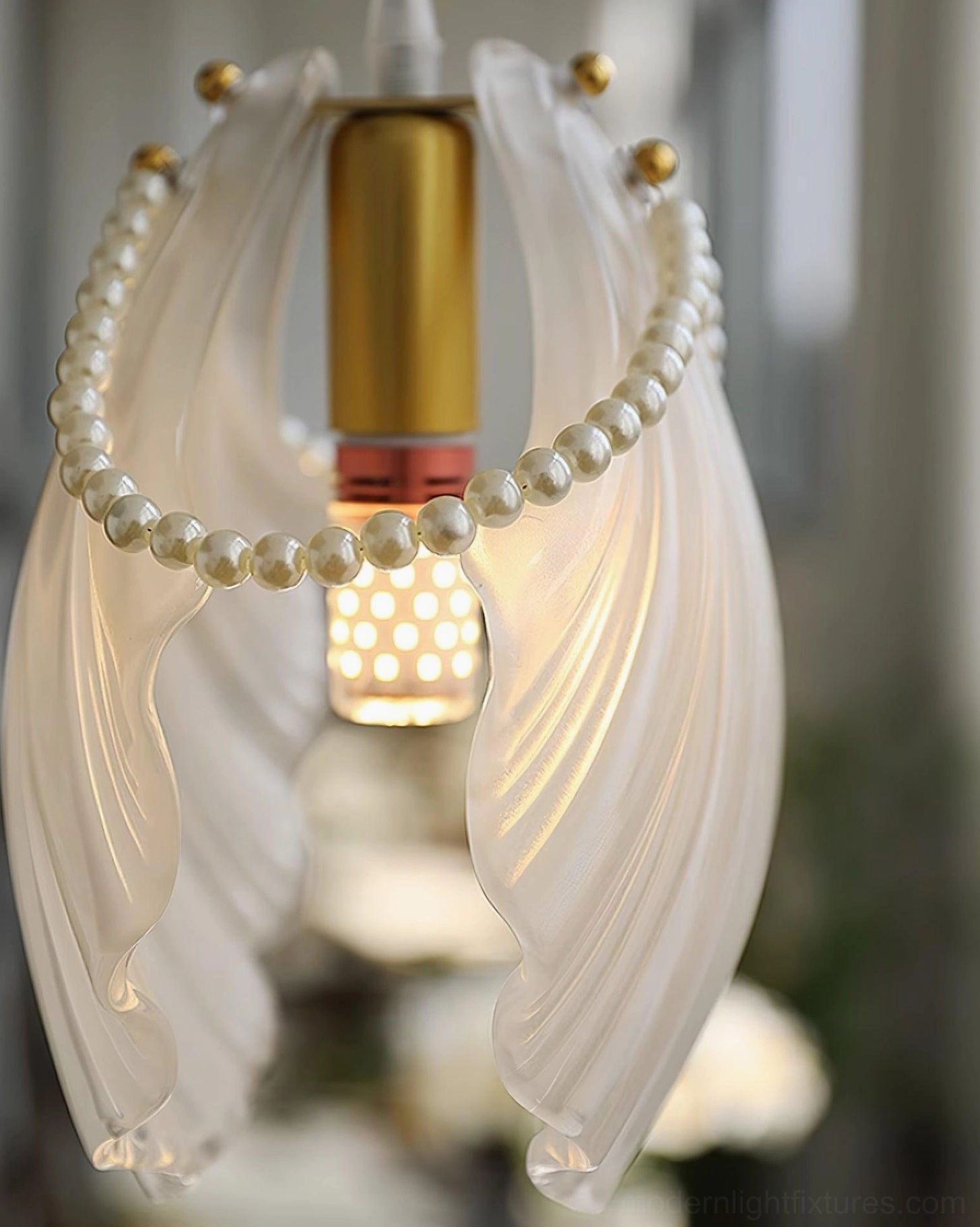 Pearl shell pendant light installation view showing versatile mounting and wire adjustment capability