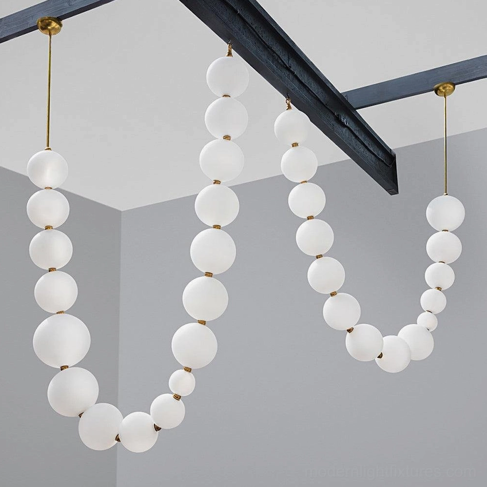 Luxury modern living space with pearl string chandelier as central focal point architectural lighting
