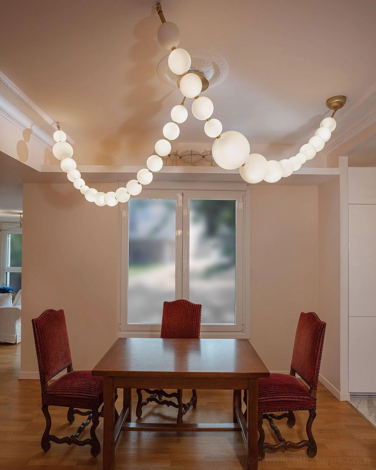 Modern pearl string light showing suspension system and ceiling mounting hardware detail