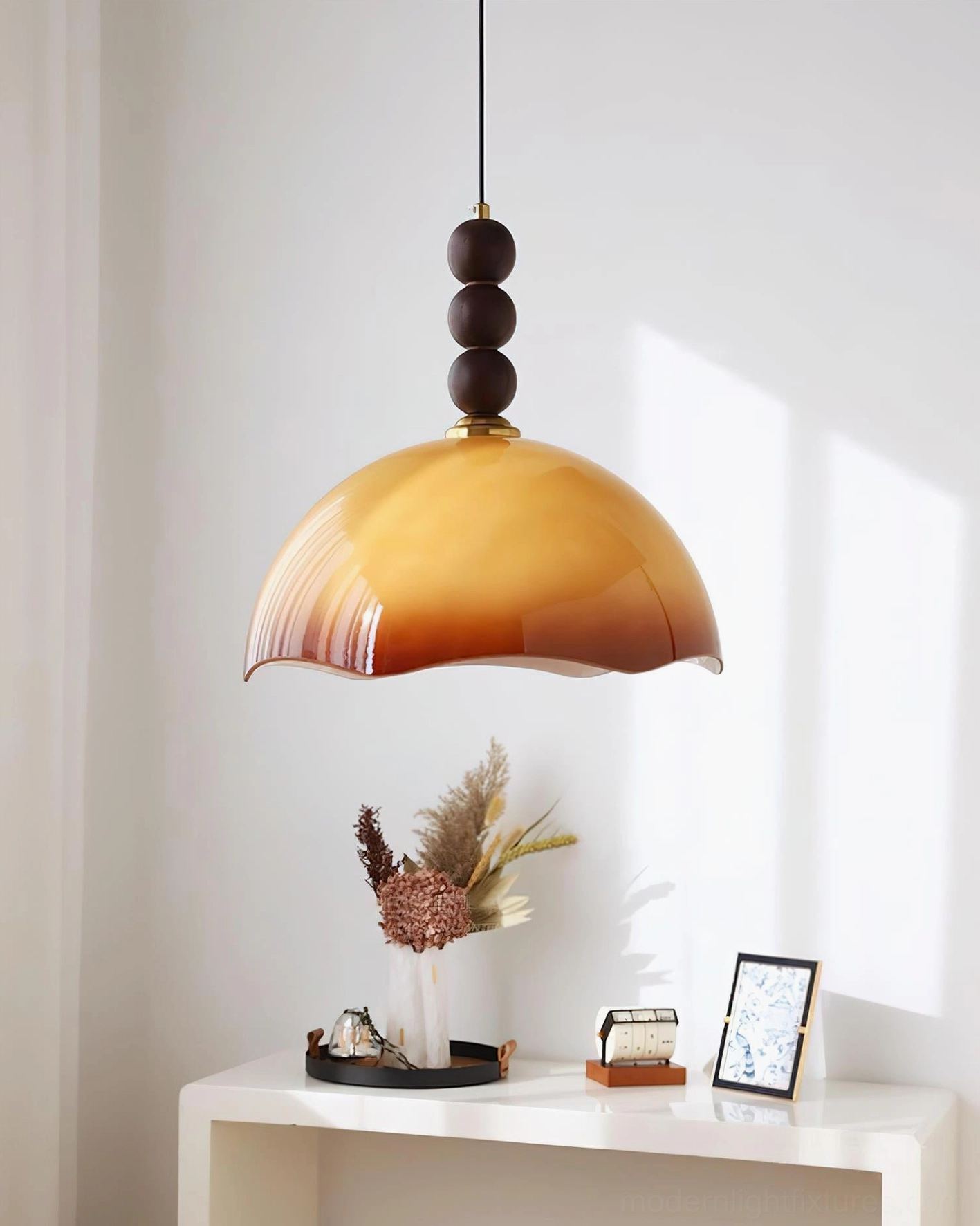Mid-century modern rippled glass pendant light in pearl white finish showing sculptural walnut sphere design