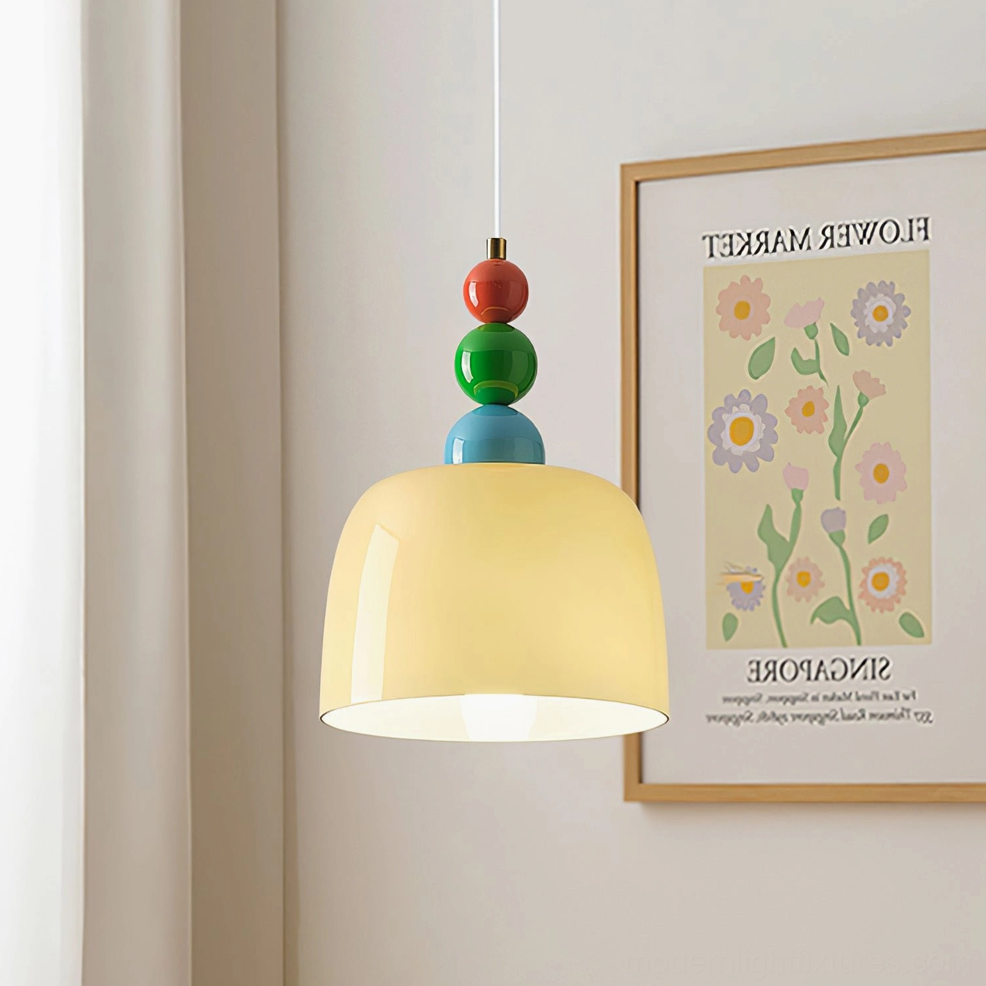 Cream glass shade pendant light with colorful beaded finial in residential bedroom corner setting