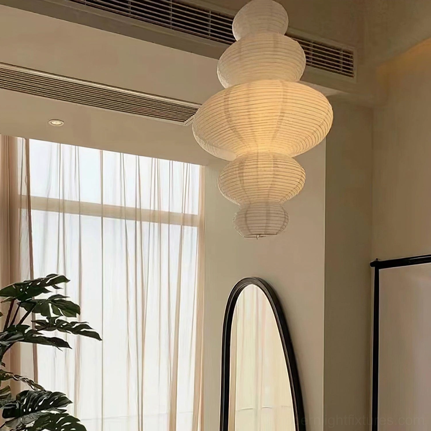 Sculptural pendant fixture in bedroom sanctuary above bed creating restful soft glow atmosphere