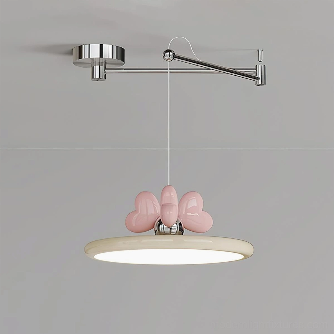 Close-up detailed view of swing arm pendant lamp showing heart-shaped bow decoration and acrylic disc shade