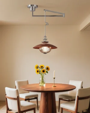 Swing arm pendant lamp installed in contemporary dining room above wooden table with sunflower centerpiece, warm ambiance