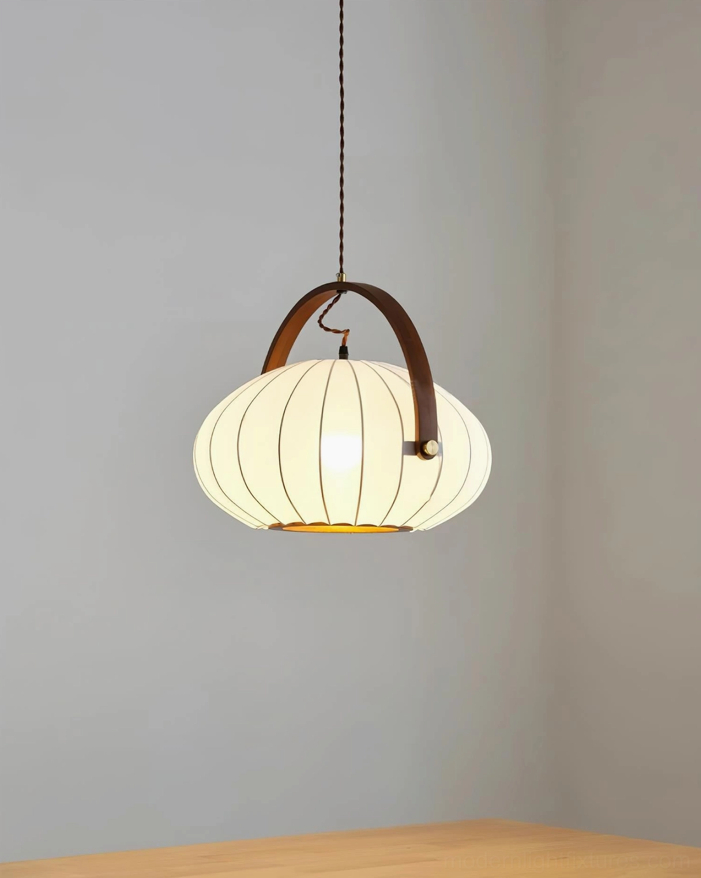 Side view of modern lantern-style pendant lamp with slim hanging cord and wooden accent handle