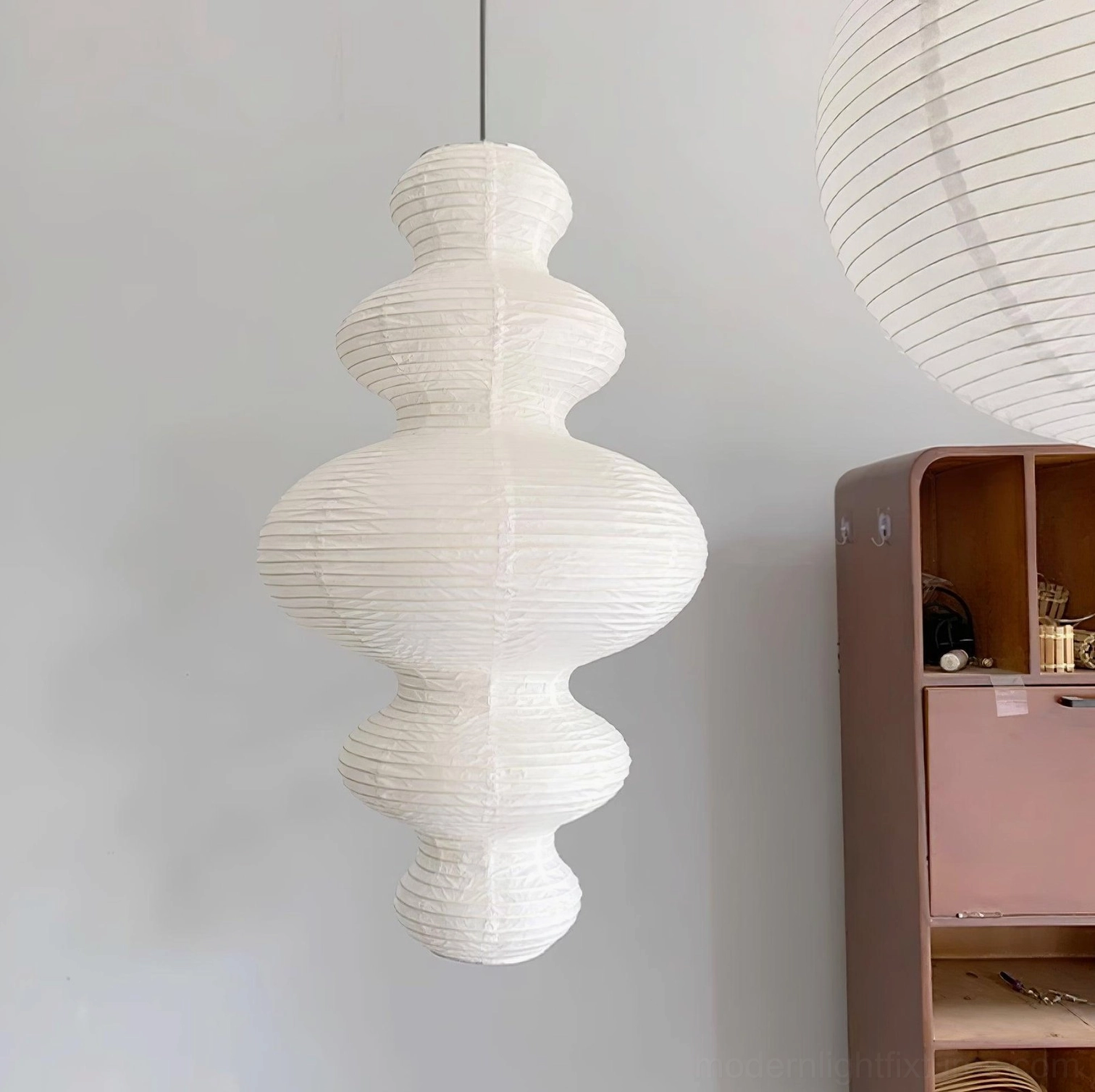 Hand-crafted pendant lamp installed in dining room with soft even light distribution across table