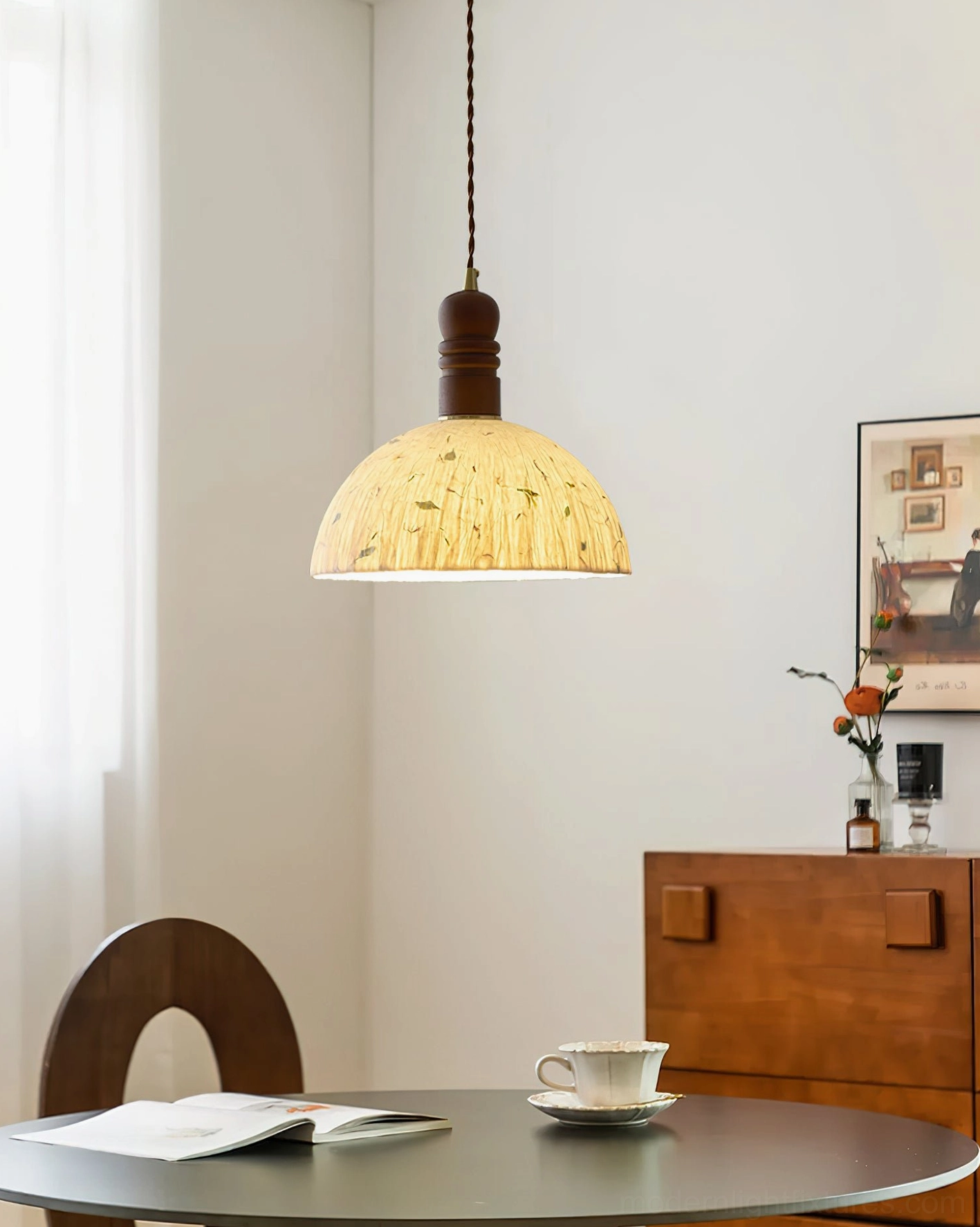 Warm yellow speckled rice paper dome pendant light in retro dining room setting with round table
